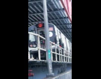 Collab WINY - Guy with selfie stick stands at the back of train