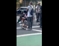 Guy on street watches game with pets