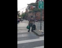 Shirtless guy black red wings green bag
