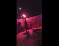 Two women in cowboy costume dance at the haystack