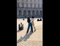 Two girls dance courtyard Louvre glass pyramid