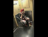 Drunk woman with frizzy hair and red hat talks on the phone on subway 