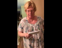 Older woman reads funny words 