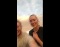 Guy sitting with friends on fast boat tries to drink beer