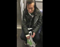 Guy plays air guitar on train