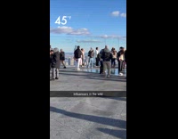 Woman small clothes poses on cold rooftop
