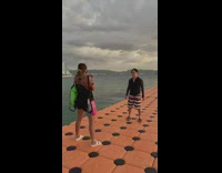 Guy rash guard dance on floating bridge