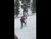 two girls poses with skis in the snow
