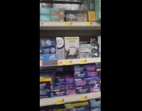 Guy looking at different toothpaste prices 