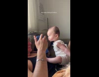 Baby being nosy while dad is on the phone