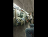 Contortionist dances to music on subway train,