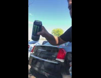 Guy pours gatorade and monster on window