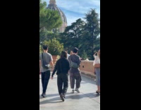 Two women photoshoot stopped on Vatican walls