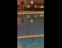 Woman printed dress beside pool handheld LED
