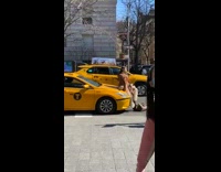 Woman brown coat sit yellow taxi street