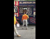 Guy lifts curls dumbbells by food truck 