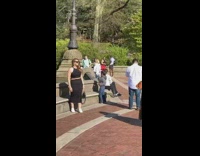 Woman black dress photo shoot public riverside