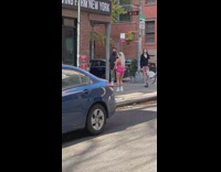 Woman pink shorts dance at street corner