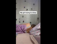 Guy plays video games while girl tries to sleep