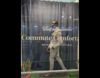 Model in gray business suit walks on treadmill on storefront window