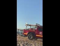 Airplane plane jet flies over beach truck 