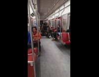 Man Holds Up Motorcycle in Subway Train