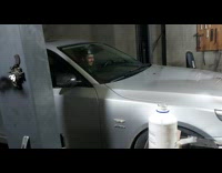 Man bounces the car in front of it in the garage