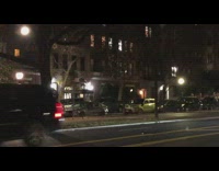 Small parade on street with cars and police escort