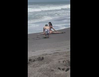 Woman pink bikini splits yoga position beach