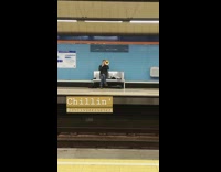 Guy playing trumpet in subway chillin