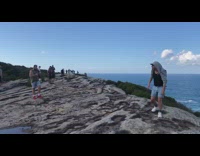 Guy grey jacket handstand mountain cliff ocean