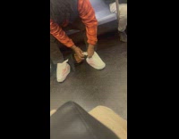 Guy wrap plastics on his shoes inside train in NYC 