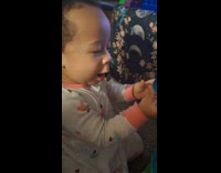 Toddler happily playing with new toy