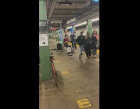 Women slow dancing with each other while guy performs on drumset