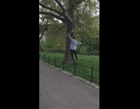 Lady balances and walks black metal railing 