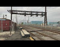 Guy watches fast blue white red train 