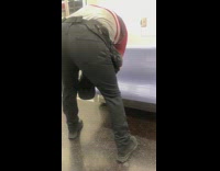 Guy wipes down purple train subway seat 