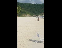 Girl posing on beach in red bikini