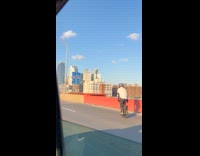Collab WINY - Guy rides one wheel scooter on bridge