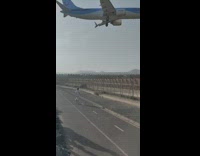 Airplane flyby with a loud engine near the beach