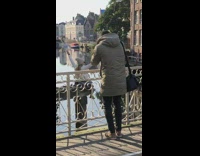 Girl sits on wood beam for photo