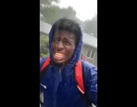 Man runs through rain to his car