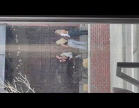 Girl sit beside etched wall middle finger