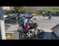 man films little boy on motorcycle starts engine