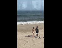 Couple poses for photoshoot at the beach Part 1