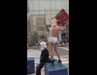 Guy in diaper holds up sign that says Forget your dream 