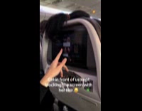 Girl on plane covers screen with hair