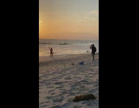 Girl beach shore sunset jumpsuit black shorts