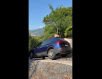 Driver slowly turning on narrow curved street 