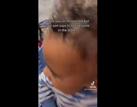 Little boy in blue shopping cart says hi to strangers 